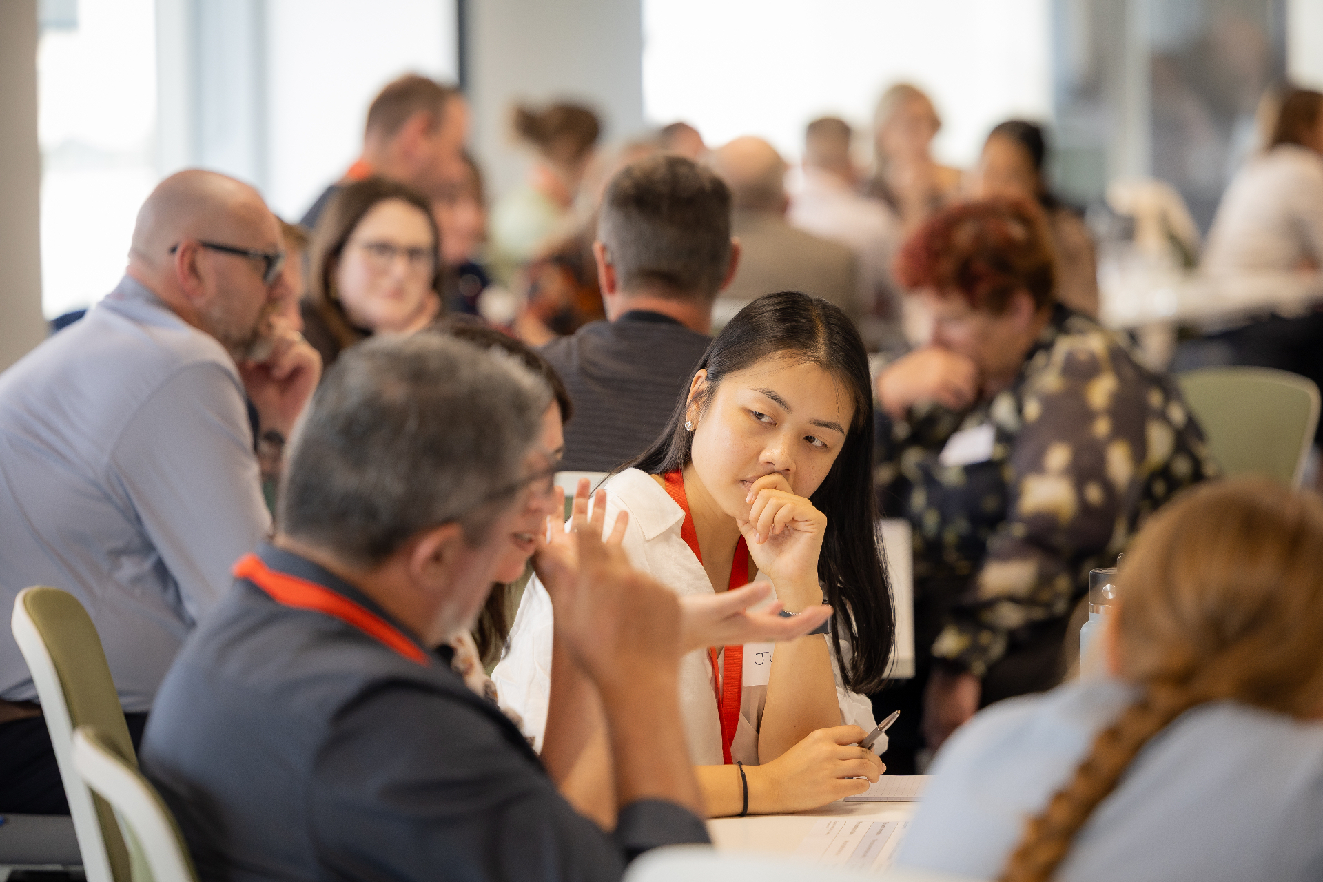A participant thinking during a workshop discussion